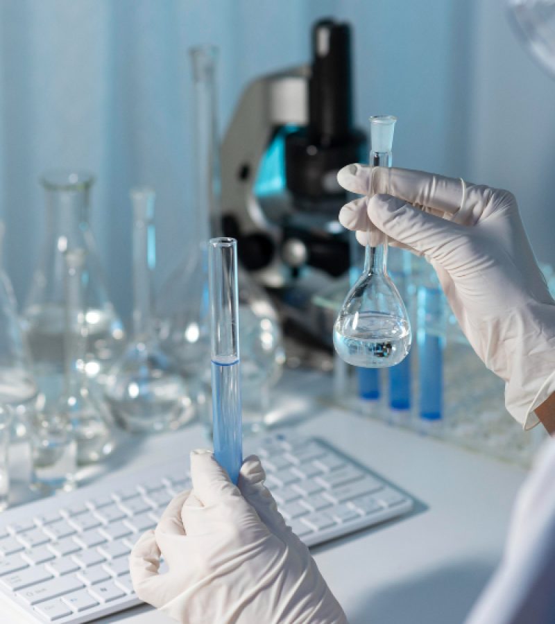 close-up-researcher-holding-glassware